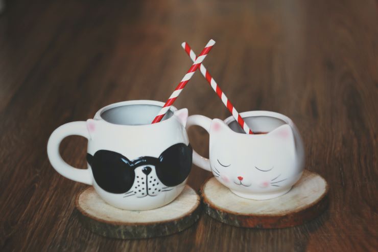 2 coffee cups in a cat shape, with straws